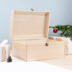 Wooden gift box with Christmas decorations on a light blue background
