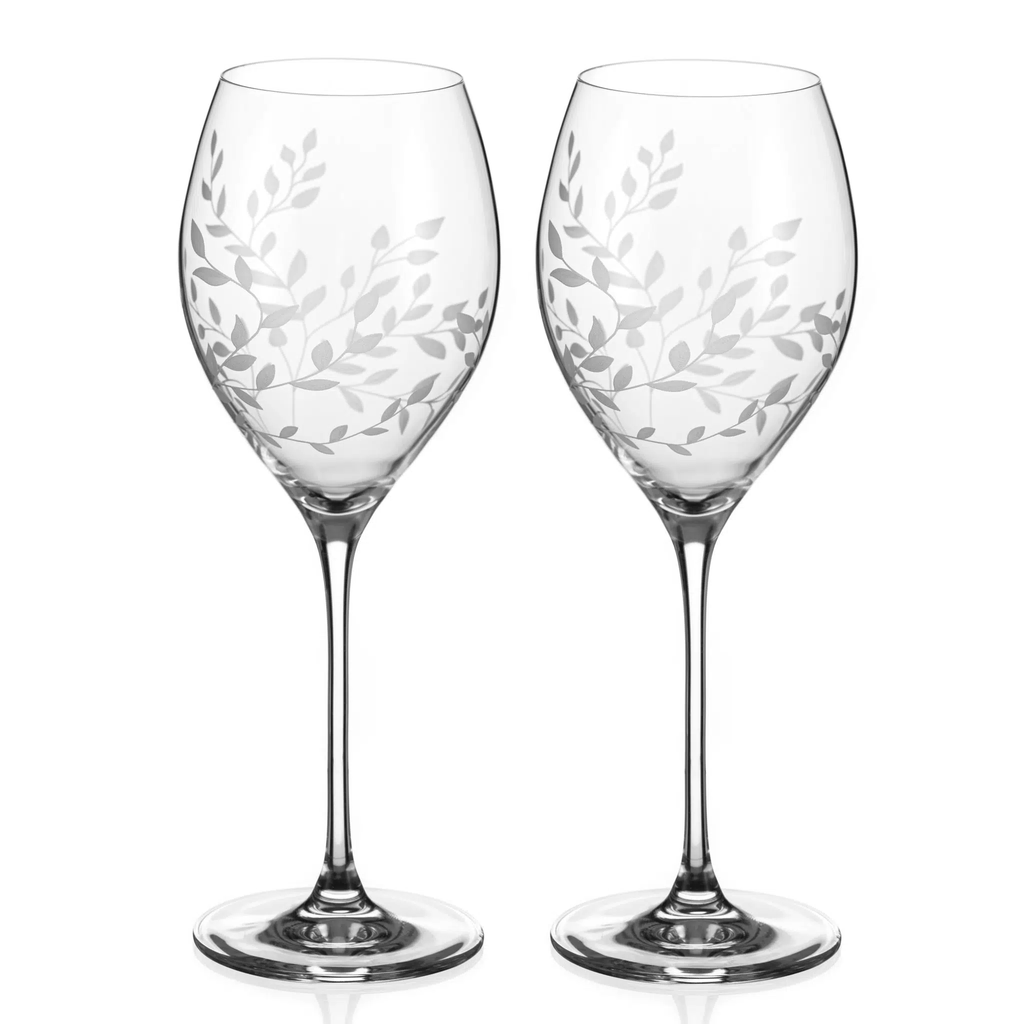 Two wine glasses with leaf pattern on a white background