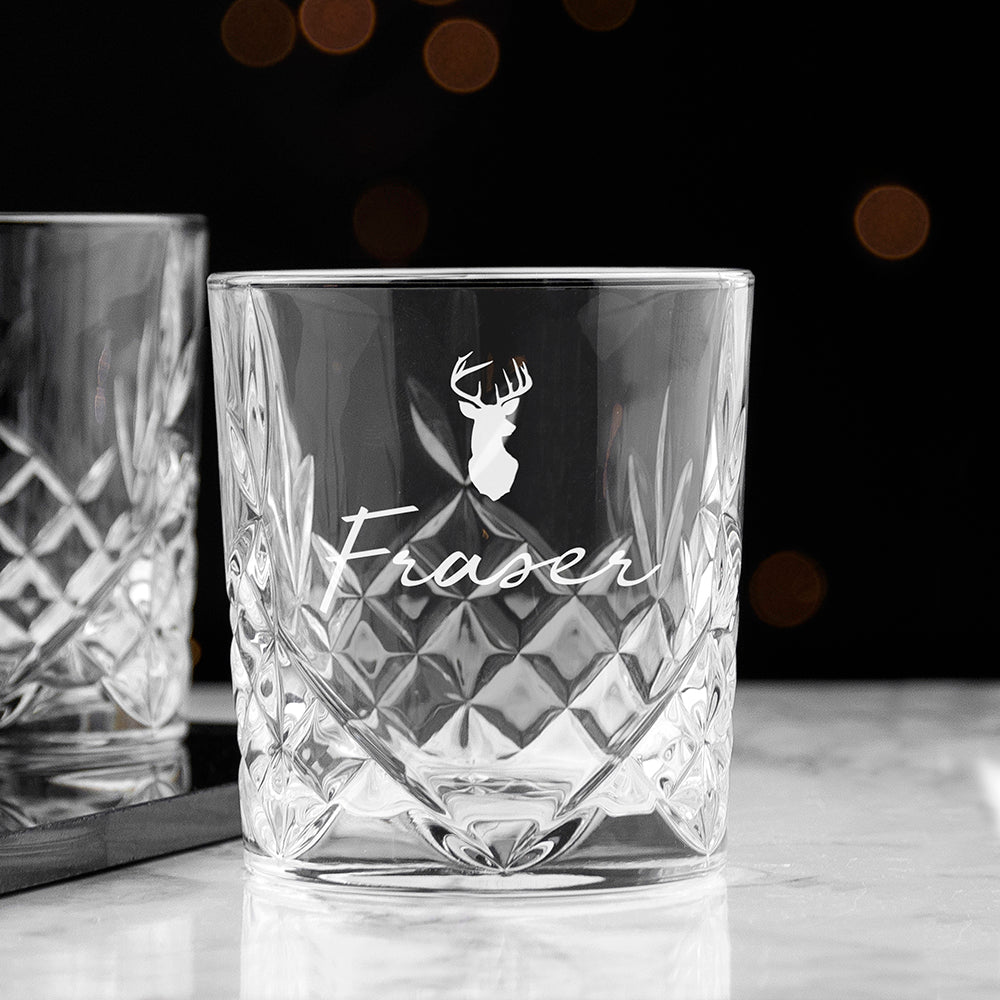Crystal glass with engraved deer head and 'Fraser' text on a dark background