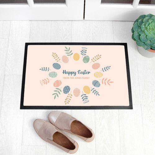 Decorative doormat with Easter design on a white floor with shoes and a plant.