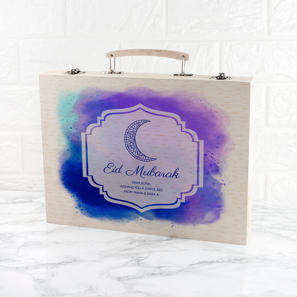 Wooden box with 'Eid Mubarak' design on a white marble background