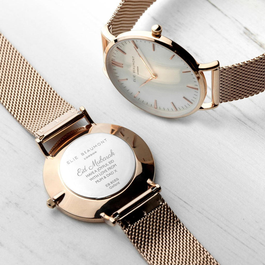 Rose gold watch with mesh band on a light background
