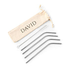 Set of metal straws with a beige drawstring bag labeled 'DAVID' on a white background