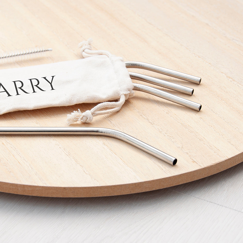 Set of metal straws with a drawstring bag on a wooden surface