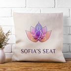 Pillow with a lotus flower design and 'Sofia's Seat' text on a white brick wall background