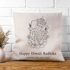 Decorative pillow with Ganesha design and text on a white brick wall background