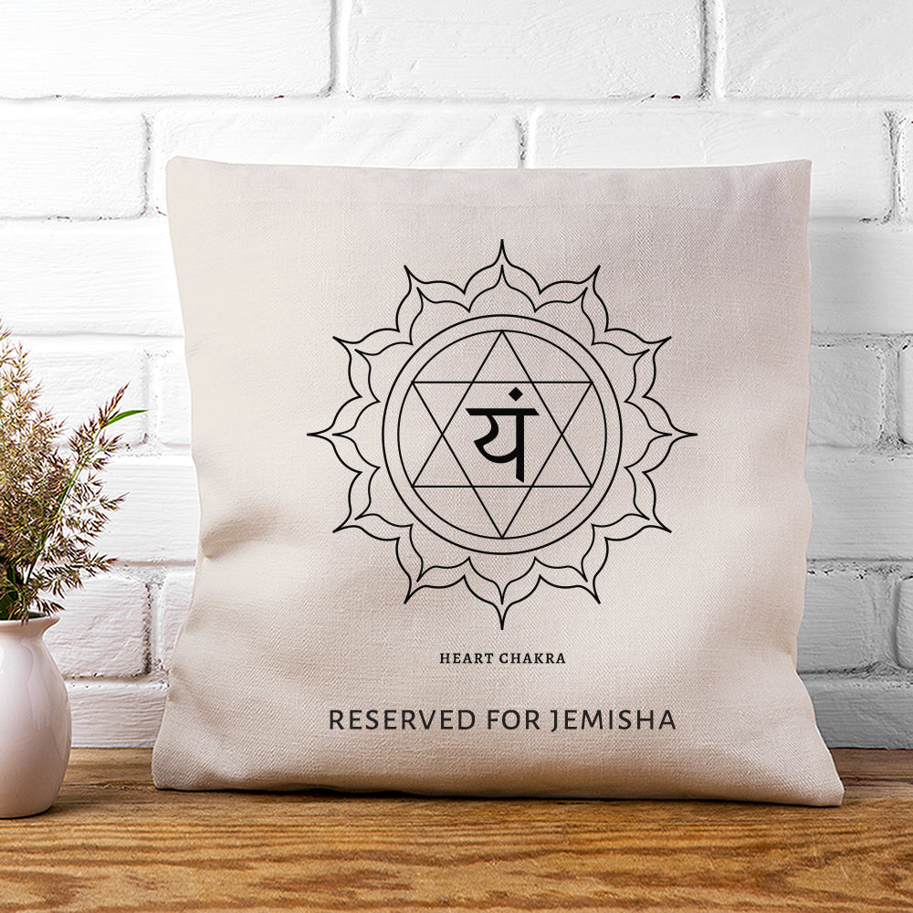 Beige pillow with a symbol and text on a wooden surface and white brick wall background
