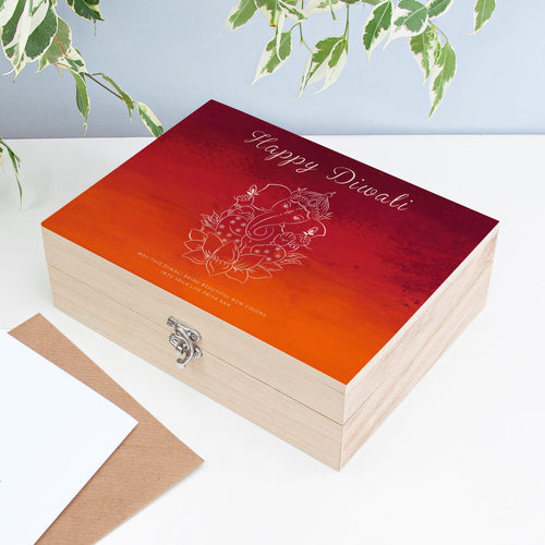 Wooden box with 'Happy Diwali' and Ganesha design on a light background