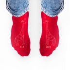 Red socks with giraffe designs and names 'Alex' and 'David' on a white background.
