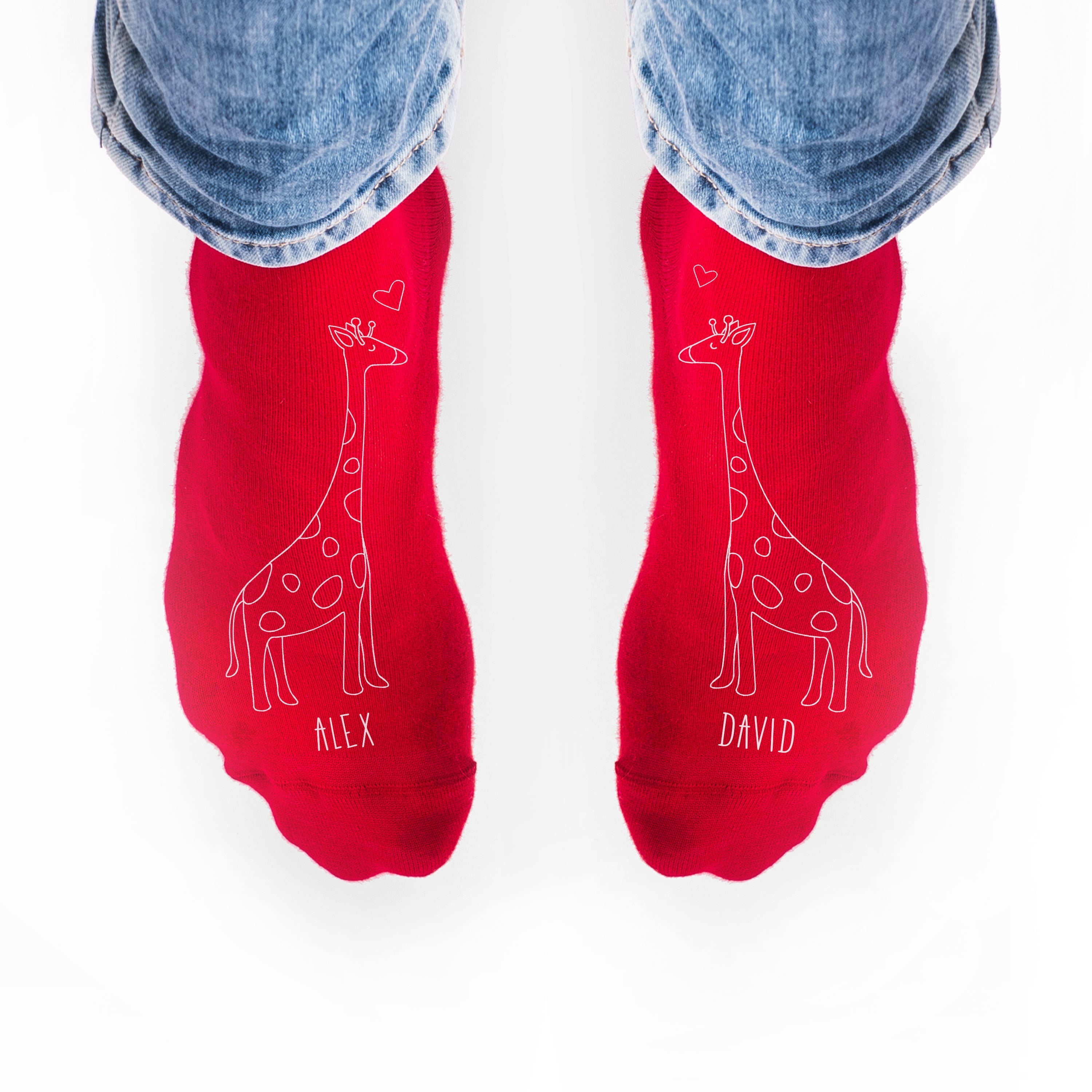 Red socks with giraffe designs and names 'Alex' and 'David' on a white background.