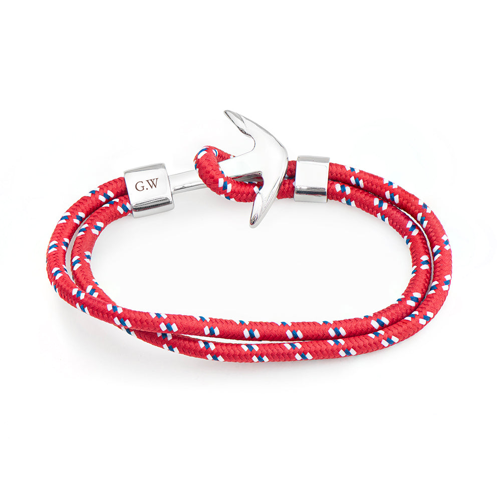 Red braided bracelet with silver anchor clasp on a white background