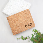 Cork cardholder with 'DAD' engraving on a light wooden surface