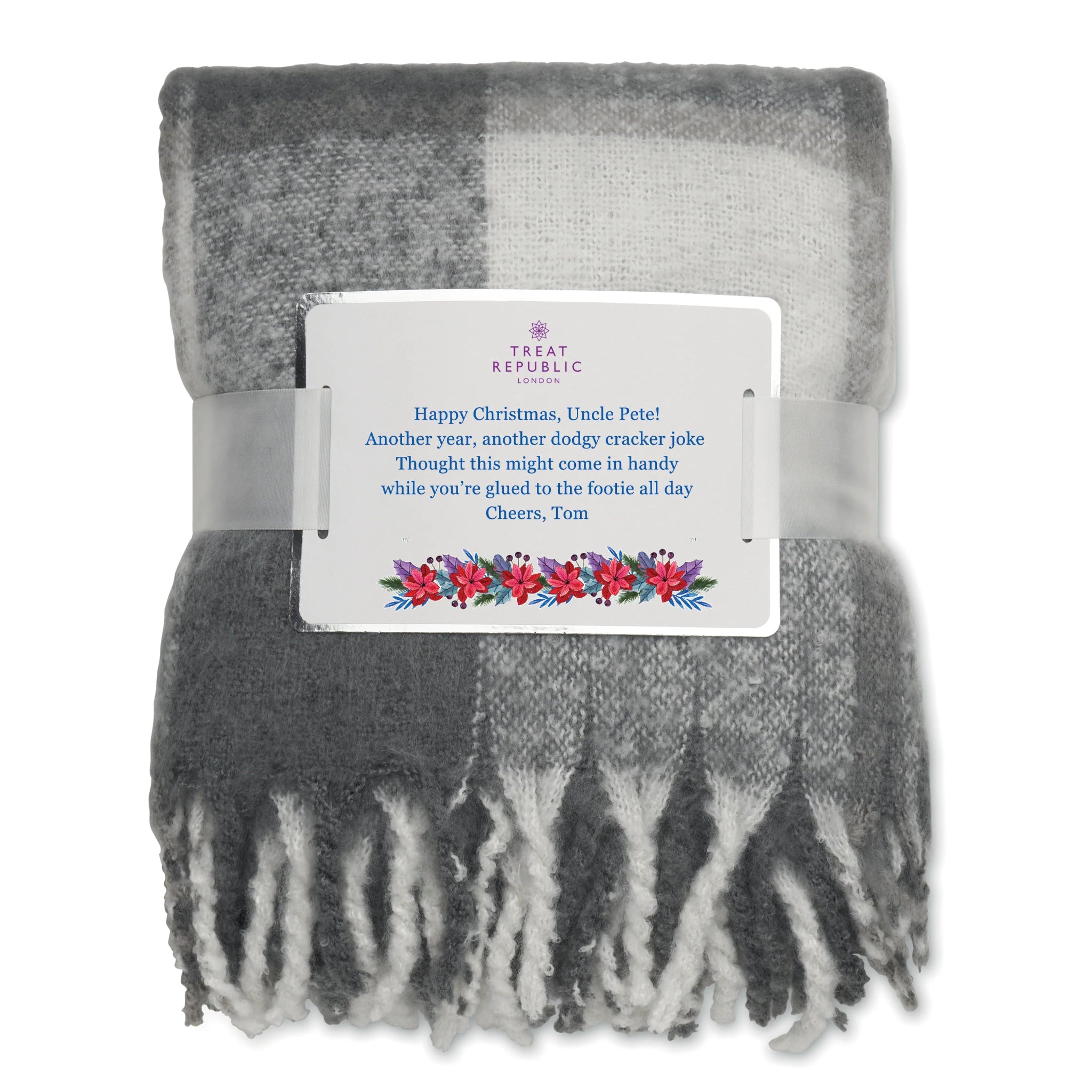 Gray and white plaid blanket with a Christmas message card on a white background