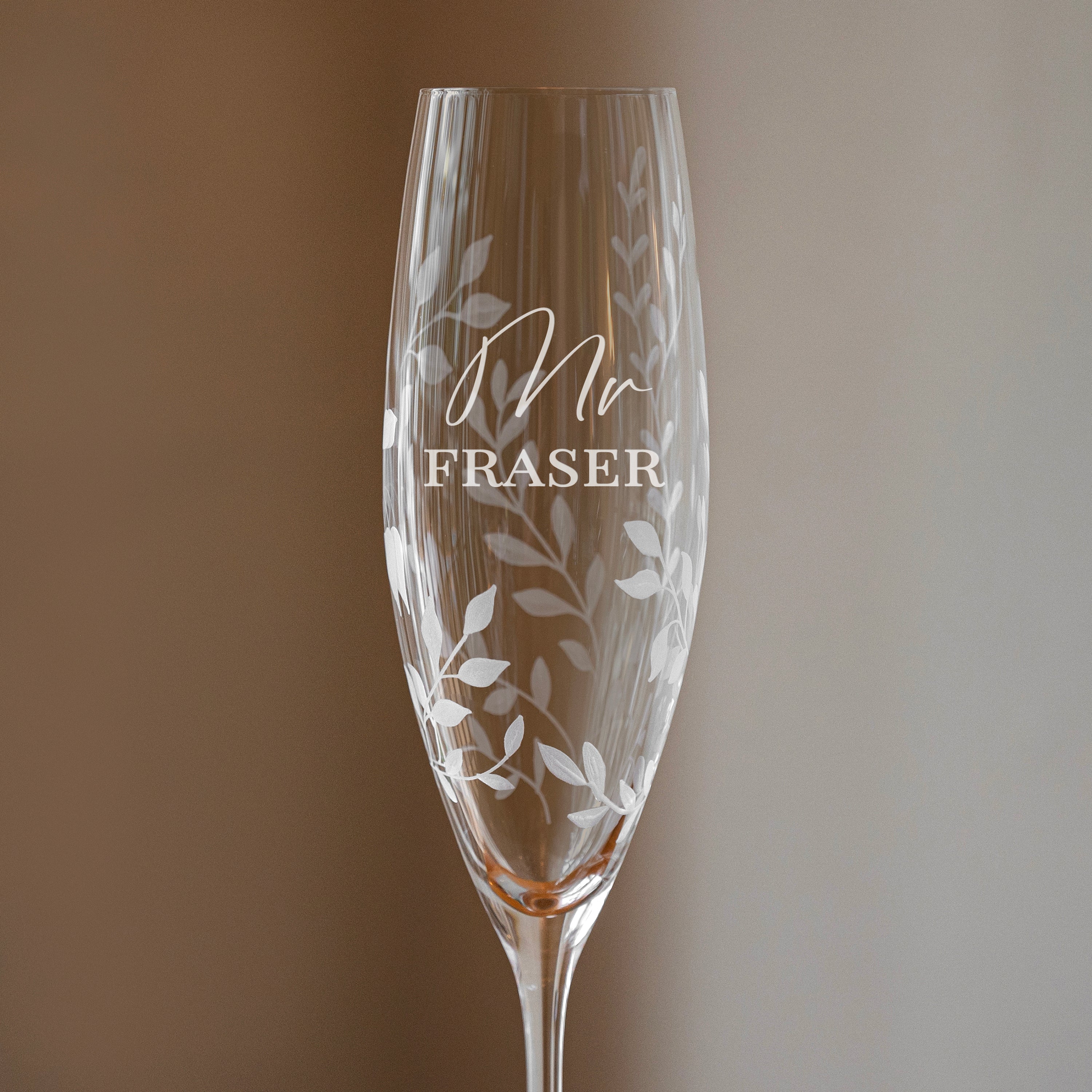 Champagne flute with 'Mr Fraser' engraving on a gradient background