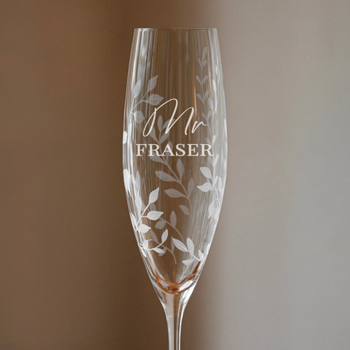 Champagne flute with 'Mr Fraser' engraving on a gradient background