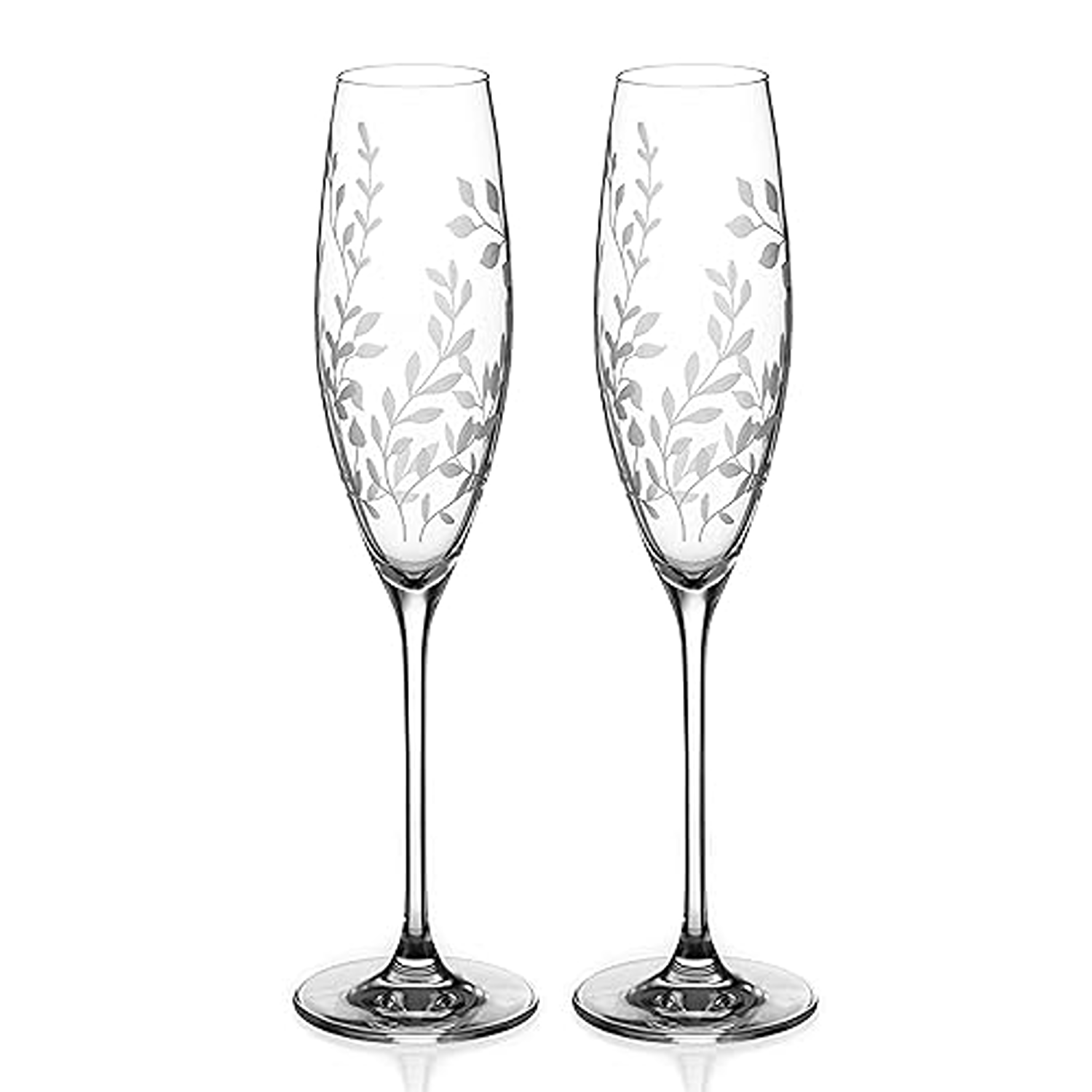 Two elegant champagne flutes with leaf patterns on a white background