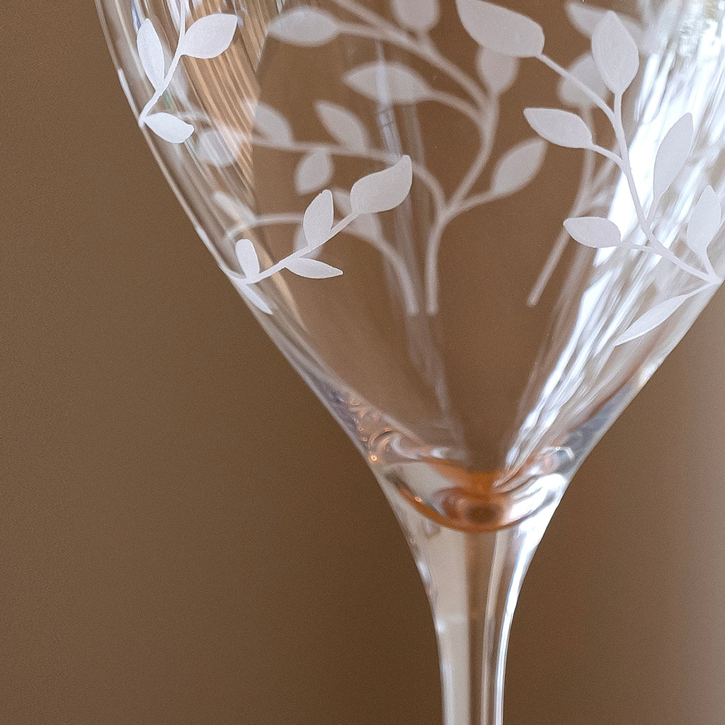 Decorative glass with leaf patterns on a brown background