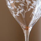 Decorative glass with leaf patterns on a brown background