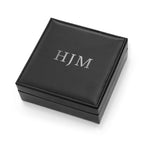 Black jewelry box with 'HJM' initials on a white background
