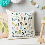 Decorative pillow with alphabet design and personalized text in a child's room.