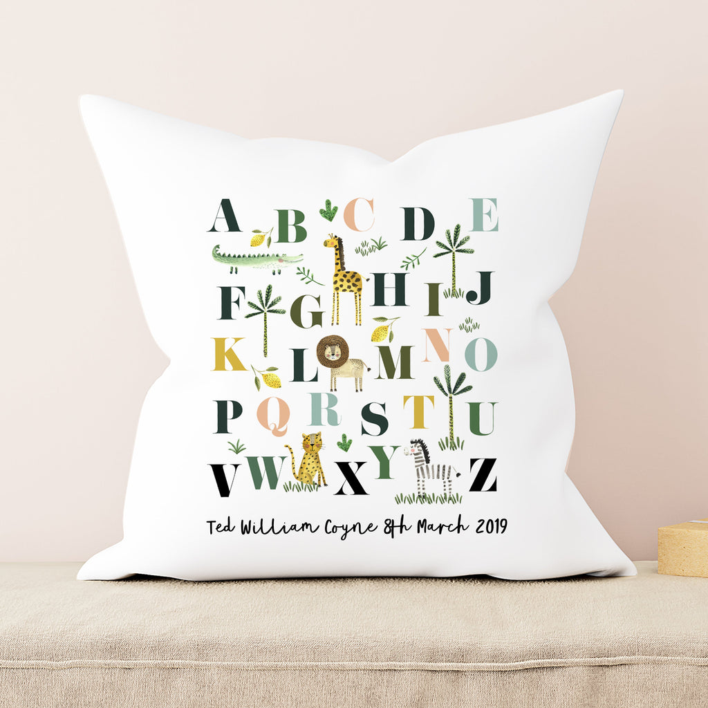 Decorative pillow with alphabet design and personalized text on a beige background