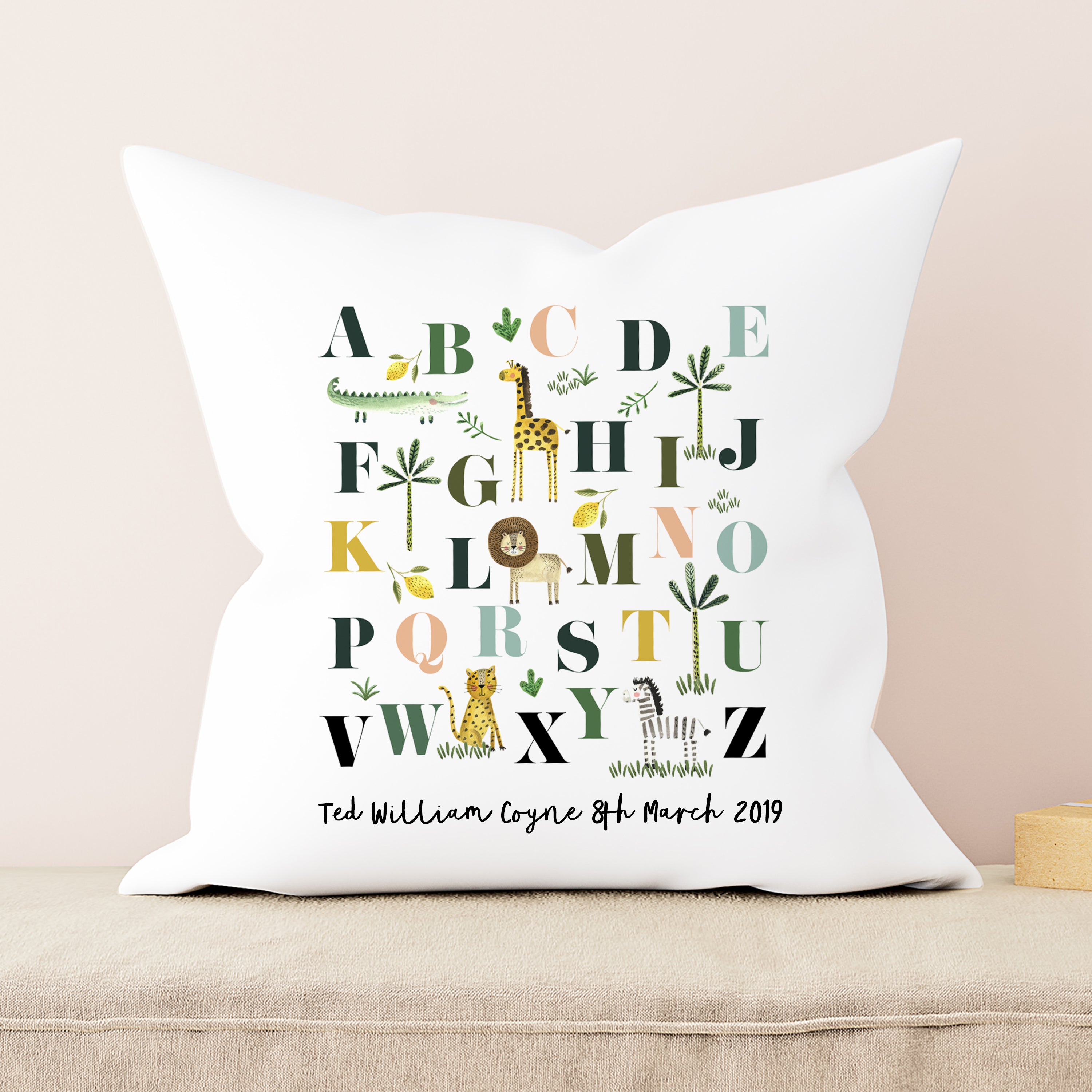 Decorative pillow with alphabet design and personalized text on a beige background