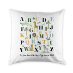 White pillow with colorful alphabet letters and animal illustrations on a white background