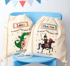 Two drawstring bags with cartoon designs and names on a blue chair.