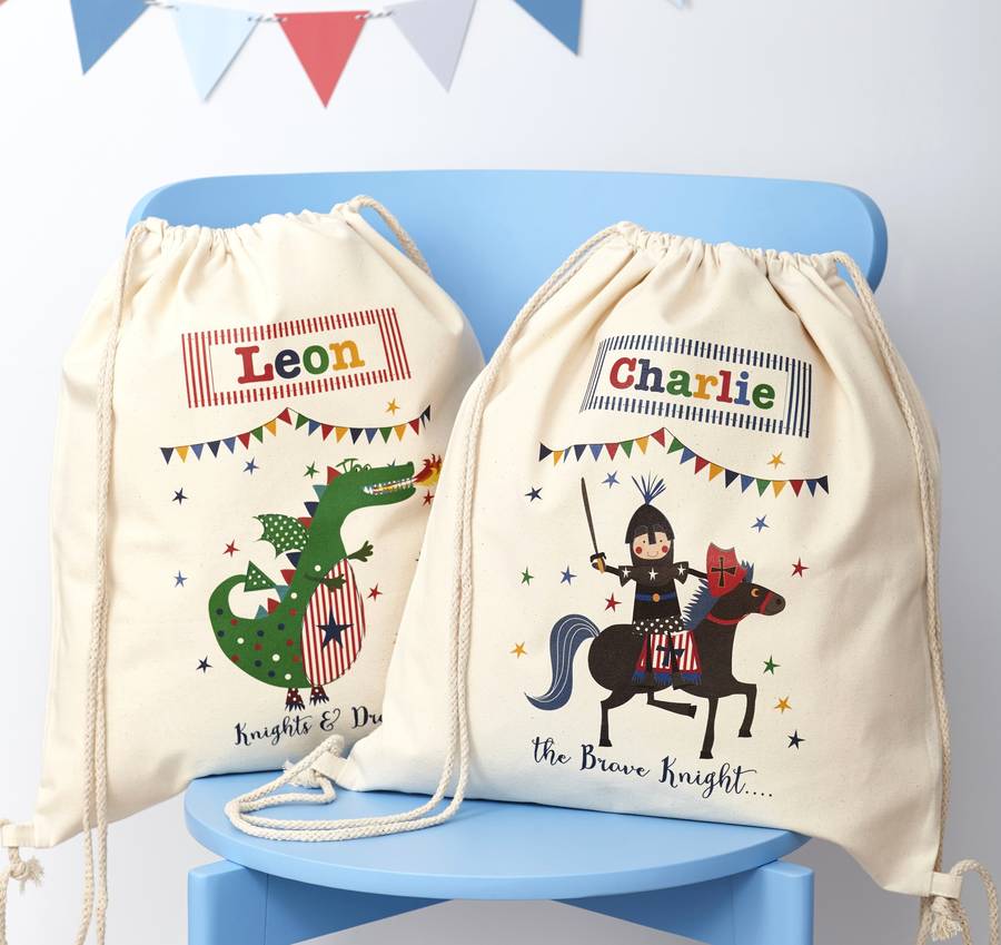 Two drawstring bags with cartoon designs and names on a blue chair.
