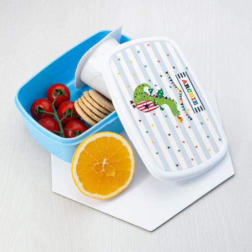 Bento box with a lizard design on a white surface