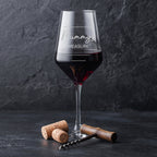 Wine glass with red wine and 'Mummy's Measure' text on a dark background