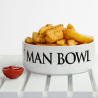 White bowl labeled 'S Man Bowl' filled with fries on a checkered tablecloth.