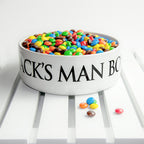 White bowl filled with colorful candies on a white surface