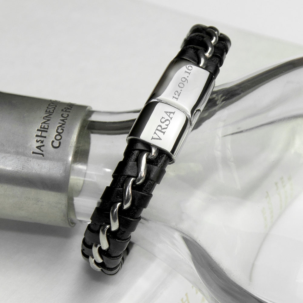 Black leather bracelet with silver clasp on a white surface