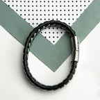 Black beaded bracelet on a white background with geometric patterns