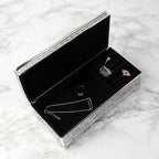 Jewelry box with necklaces and rings on a marble surface