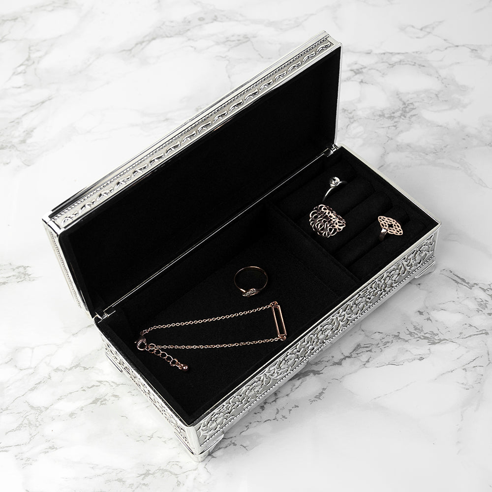 Jewelry box with necklaces and rings on a marble surface