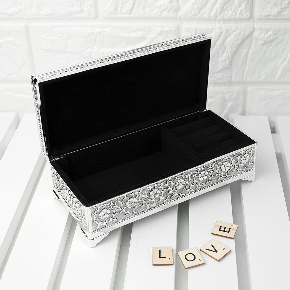 Decorative jewelry box with intricate patterns on a white surface.