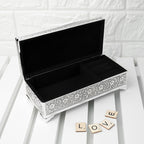 Decorative jewelry box with intricate patterns on a white surface.