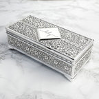 Decorative silver jewelry box on a marble surface