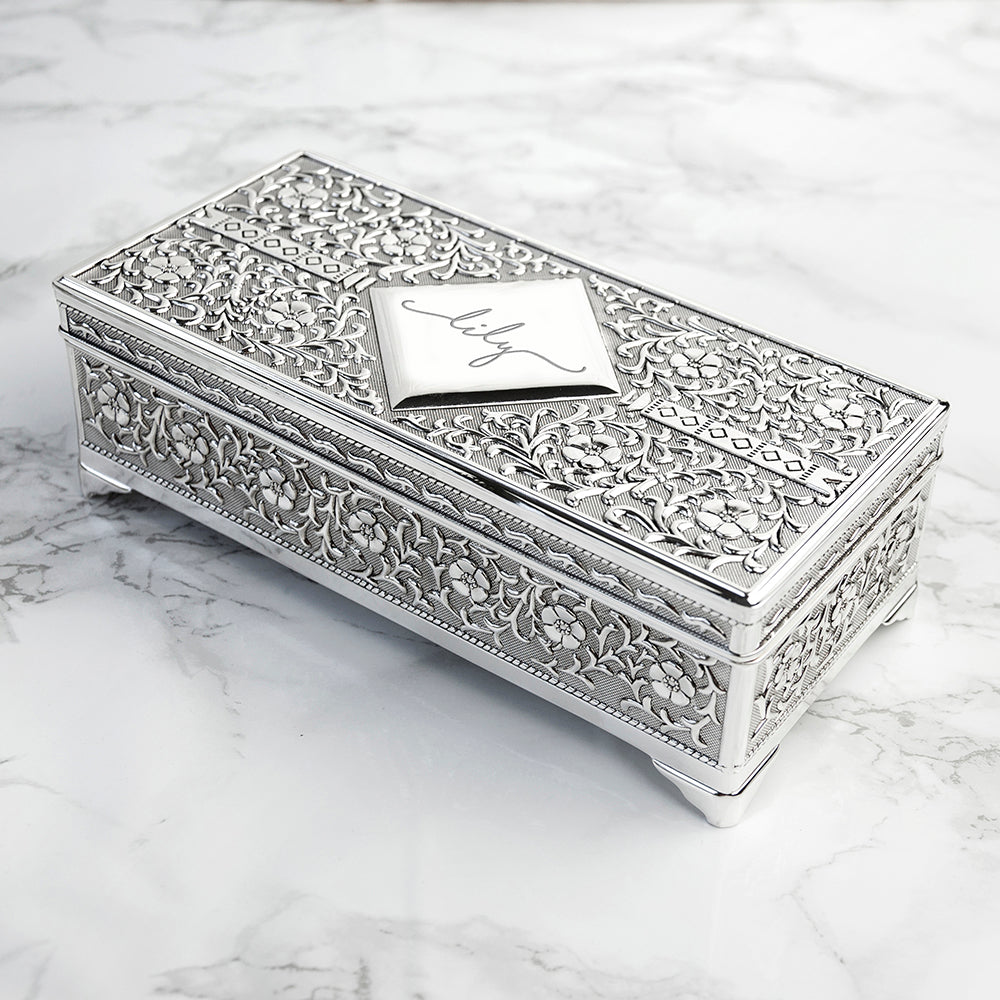 Decorative silver jewelry box on a marble surface