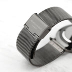 Silver watch with mesh band on a white background, featuring 'Mr Beaumont' branding.