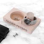 Wooden jewelry tray with watch, cufflinks, and wallet on a marble surface