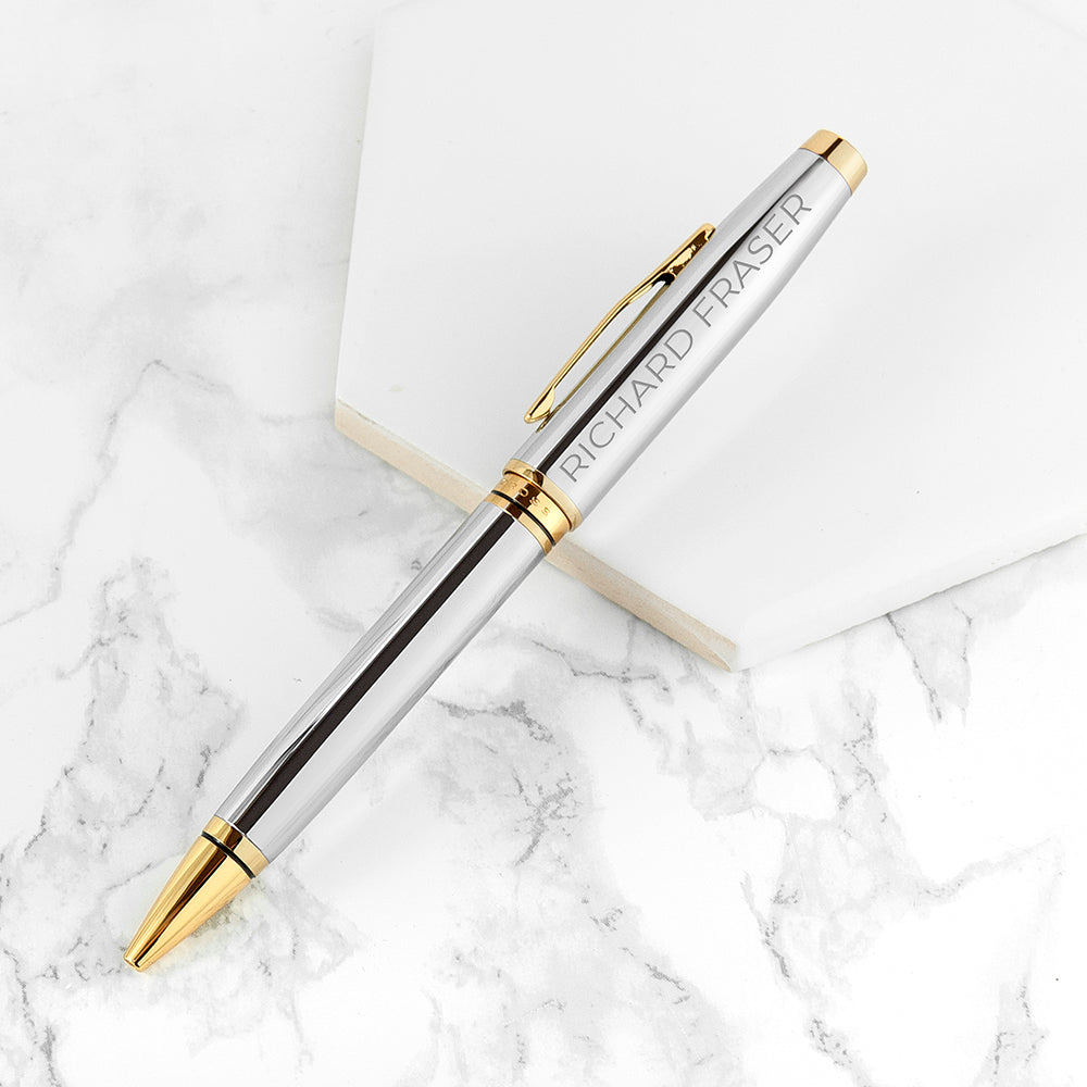 Silver pen with gold accents on a marble surface