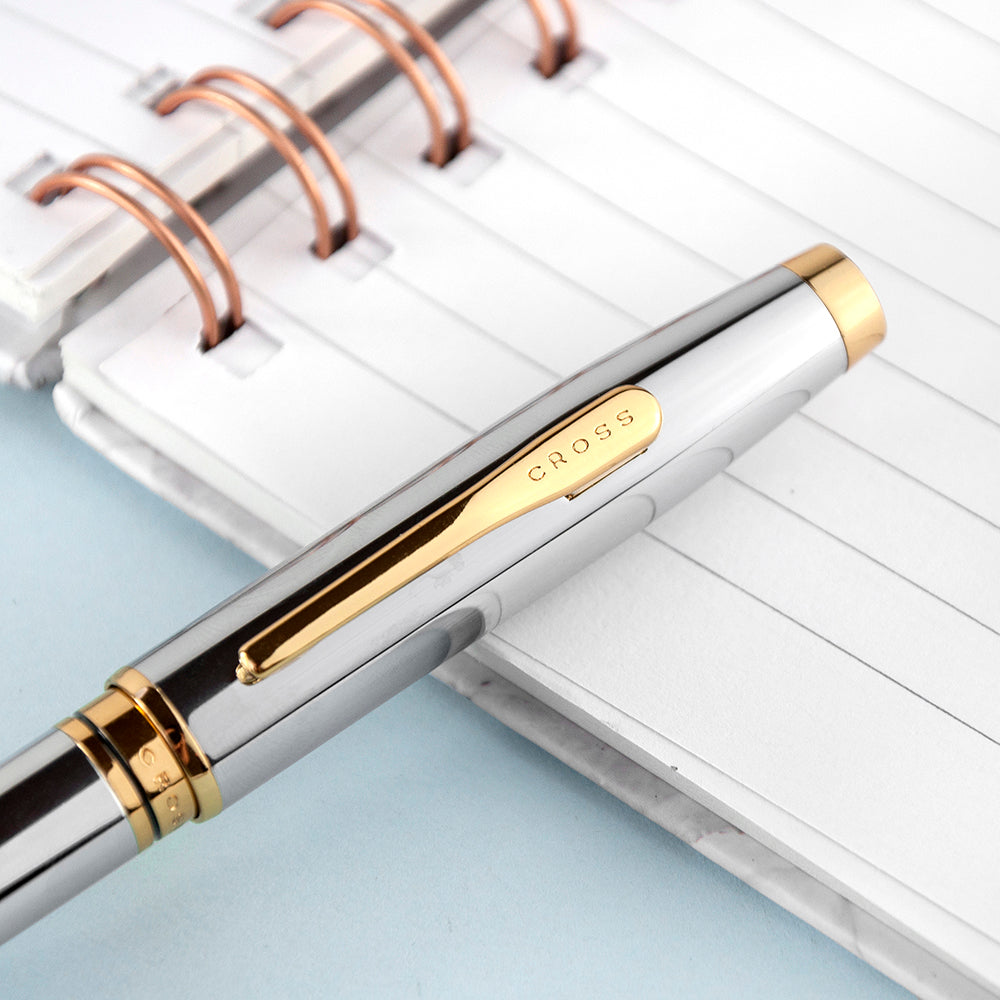 Cross pen with gold accents on a notebook