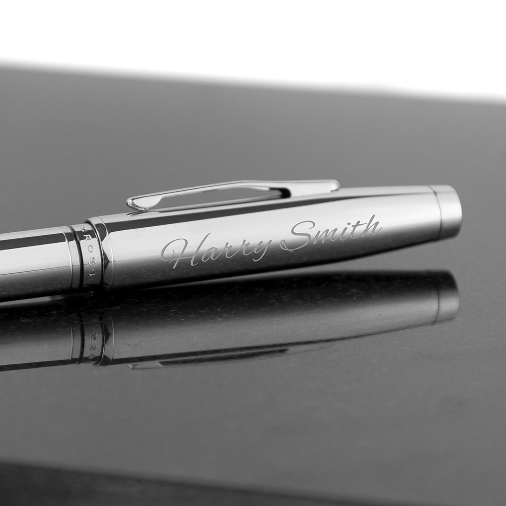 Silver pen with 'Harry Smith' engraving on a reflective surface