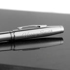 Silver pen with 'Harry Smith' engraving on a reflective surface