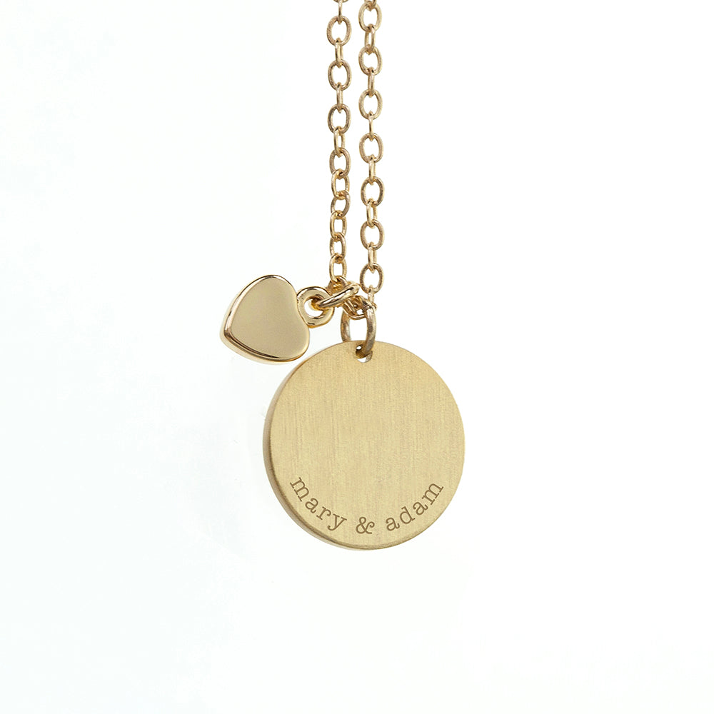 Silver necklace with a round pendant featuring the name 'ella' and butterfly designs on a white background.