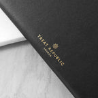Black product with 'Treat Republic London' logo on a marble surface