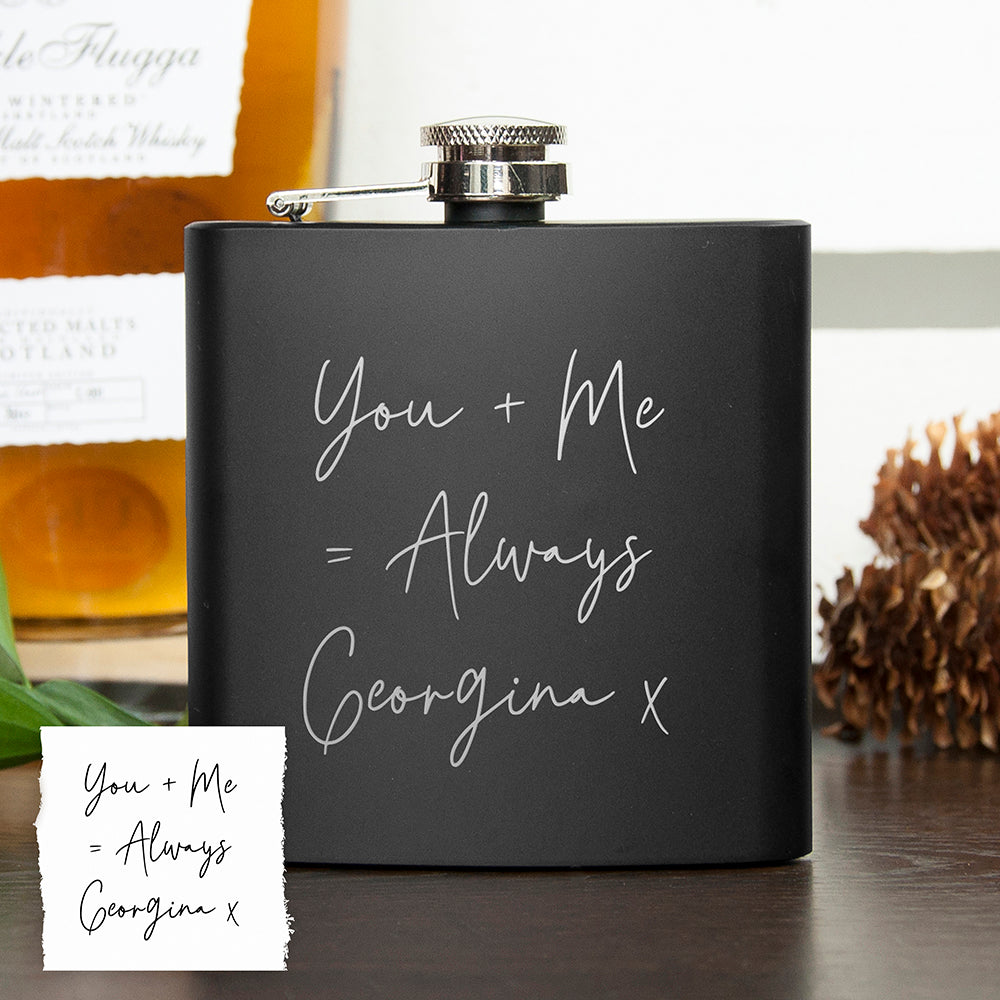 Black flask with 'You + Me = Always Georgina' text on a wooden surface.